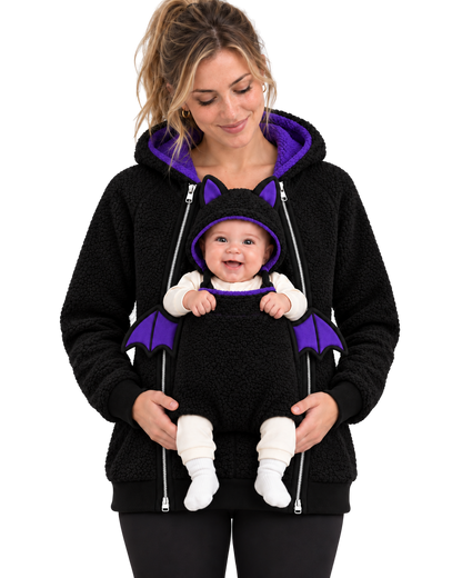 Mom wearing the black Bat hoodie with purple hood lining. Baby sits in the front pouch wearing the bat-ear hood, purple wings on each side.