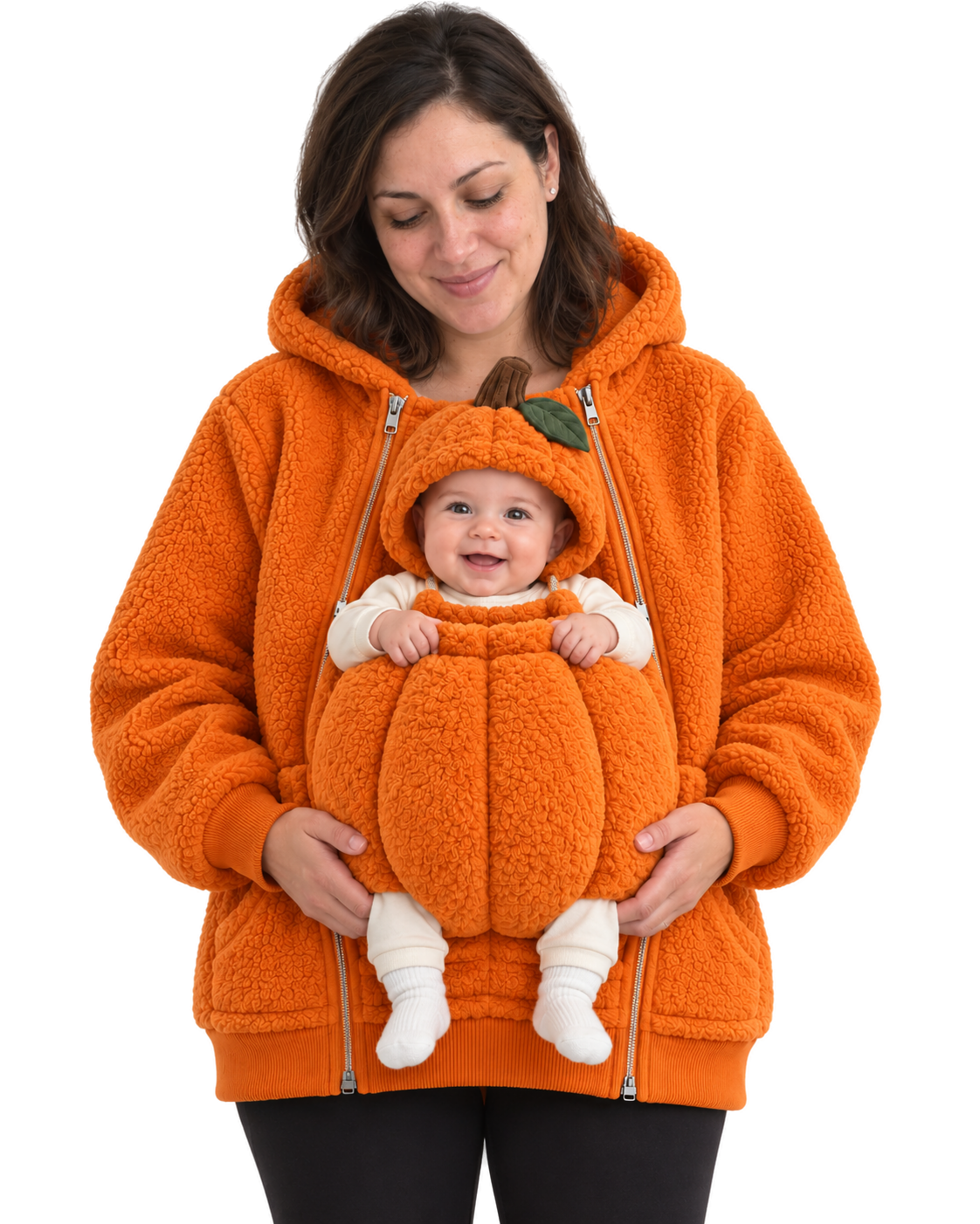 Mom wearing the orange Pumpkin hoodie. Baby sits in the front pouch wearing the matching pumpkin hood with stem and leaf, both socked feet showing.