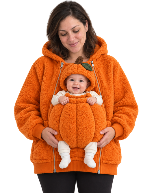 Mom wearing the orange Pumpkin hoodie. Baby sits in the front pouch wearing the matching pumpkin hood with stem and leaf, both socked feet showing.